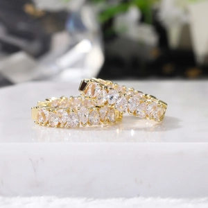 Macro shot of gold hoop earrings featuring double rows of pear-cut AAA cubic zirconia
