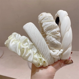 Detailed set of four cream white headbands including satin pleats and pearl accents