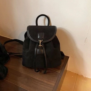 Minimalist black faux suede backpack for women with gold hardware and drawstring closure