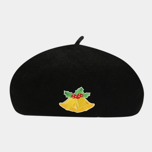 Detailed close-up of Christmas bell embroidery on a black wool beret hat