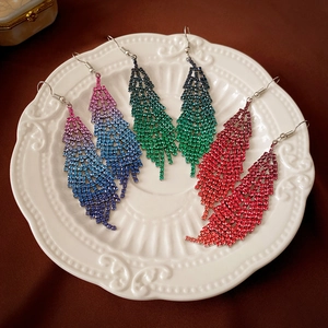 Sparkling diamond feather fringe earrings in blue, green, and pink gradient crystals