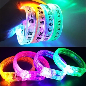 Detail view of colorful glowing LED wristbands with glitter effect for concerts