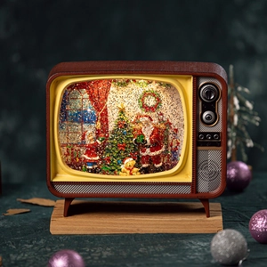 Vintage TV Christmas water globe with Santa and snow scene on dark background