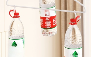 Close-up of white heavy duty metal hanger supporting three 550ml water bottles for load capacity