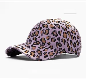Close-up of distressed brim with lilac leopard print on vintage style cotton baseball cap