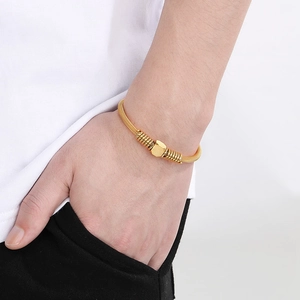 Minimalist gold cable wire bangle with square sugar cube charm for women on wrist