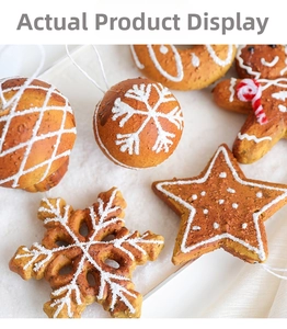 Macro shot of gingerbread-style Christmas ornaments with white icing on snow background