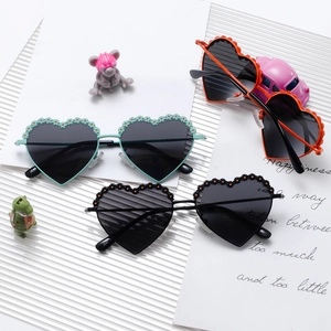 Kids heart-shaped polarized sunglasses with floral accents in mint, orange, and black