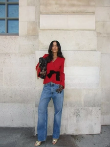 Women red wrap blazer jacket with black bow waist and casual blue high-waist jeans