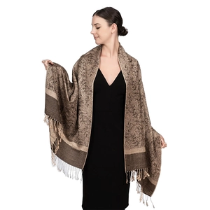 Detail of luxury paisley jacquard shawl in beige and brown with fringe edges