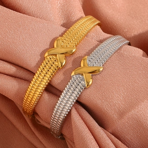 18K gold plated stainless steel bracelet with X-pattern and mesh texture on satin fabric