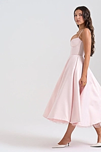 Side view of elegant light pink midi dress with thin straps and structured bodice