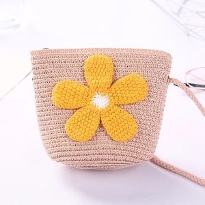 Cute pink straw bucket bag for girls with yellow crochet flower and woven shoulder strap