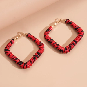 Detailed view of square hoop earrings featuring red and black leopard print pattern