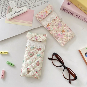 Detailed view of quilted cotton glasses pouches with cute floral patterns and lace trim