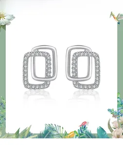 Detail view of double rectangular 925 silver earrings with zircon-set geometric design