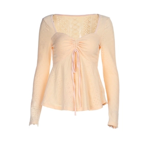 Apricot long sleeve knit top with v-neck drawstring and lace-up hollow design