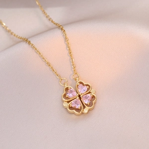 Golden necklace with pink heart-shaped crystals forming a four-leaf clover pendant