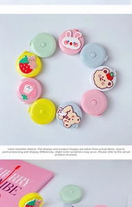 Macro view of assorted cartoon mini retractable measuring tapes in pastel colors