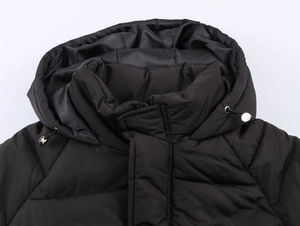 Detail view of hooded collar with metal drawstring toggles on black puffer jacket