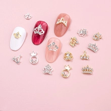 Pink themed nail charms with alloy crown and ring designs on manicured nails