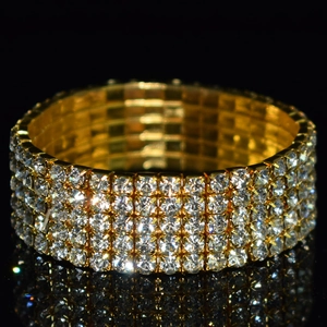 Detailed macro view of four-row sparkling crystals on a golden stretch bridal bracelet