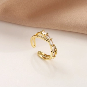 Detail of adjustable gold ring featuring a double band design with sparkling zircon stones