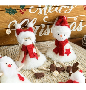 Close-up of plush Santa and elk ornaments on a woven mat with Merry Christmas decor