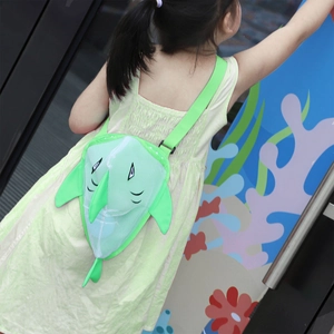 Green shark mesh beach bag for kids with adjustable strap shown on a young girl