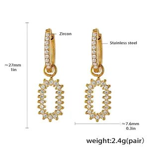 Detail of gold stainless steel butterfly earrings with brilliant-cut zircon stones