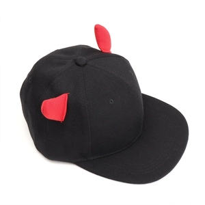 Detail of black snapback cap featuring 3D red devil horns on high quality cotton twill fabric
