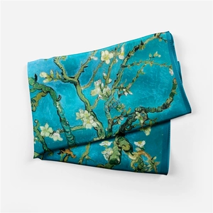 Detail of folded silk scarf featuring Van Gogh's Almond Blossoms on blue background