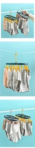 Close-up of green and yellow multi-clip drying rack for socks and small laundry