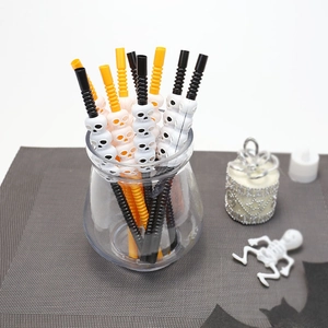 Detail of Halloween plastic straws with 3D skull designs in black, orange and white
