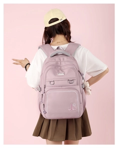 Rear view of a lightweight purple travel backpack for students with adjustable straps
