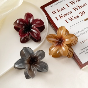 Three gradient floral hair claw clips in red, amber, and grey for women's updos