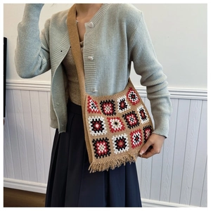 Detail of khaki crochet tote bag with geometric granny squares and fringe trim texture