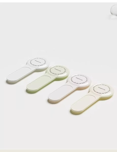 Four colorful portable toilet lid lifters in white, green, pink, and beige minimalist design