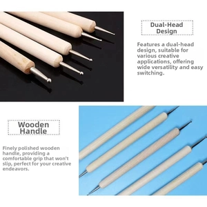 Close-up of dual-ended sculpting tools with wooden handles for pottery and clay art