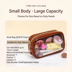 Brown leather travel makeup bag with clear window and gold zipper for toiletries