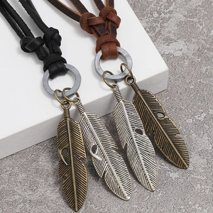 Adjustable leather necklace featuring vintage metal feather pendants in black and brown