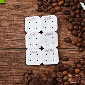 Detailed view of white earring display cards with Fashion logo and 5.7x8.5cm dimensions