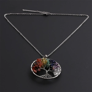 Detailed view of life tree heart pendant with multicolor gems on silver steel chain