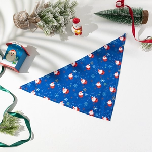 Detailed view of blue Christmas pet triangle scarf with Santa Claus and snowflake patterns
