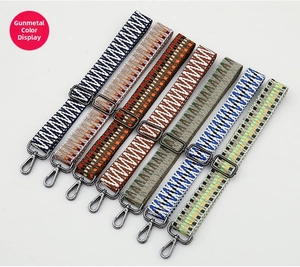 Detail of adjustable ethnic style woven bag straps with gunmetal metal hooks and hardware