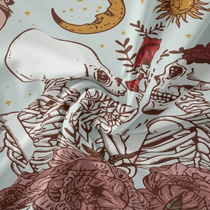 Detailed macro view of bohemian tapestry featuring skull, rose, and crescent moon patterns