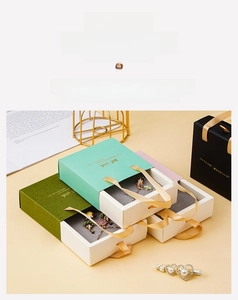 Detail of drawer-style jewelry gift boxes with satin handles in multi-color finishes