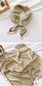 Detail of silk square scarf with champagne gold base and black chain print pattern