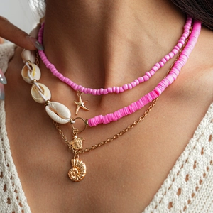 Three-layer ocean theme necklace with pink beads, sea shells and gold starfish pendants