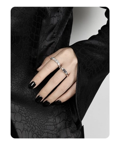 Close-up of S925 sterling silver geometric rings with zircons on dark aesthetic background